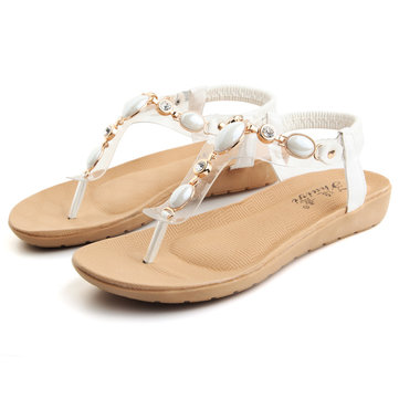 La nouvelle perle de bijoux d'appartement de femmes coupe des chaussures de massage d'orteil les chaussures de sandale uniques